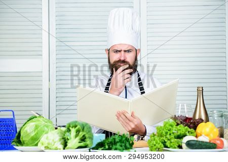 Ultimate Cooking Guide Step By Step. Book Recipes Copy Space. Man Chef In Hat And Apron Read Book. C