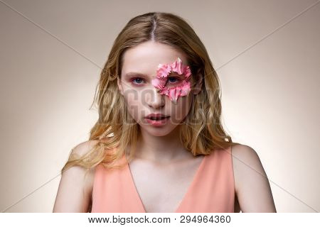 Model With Pink Eyeshades Having Flower Petals Around Eye