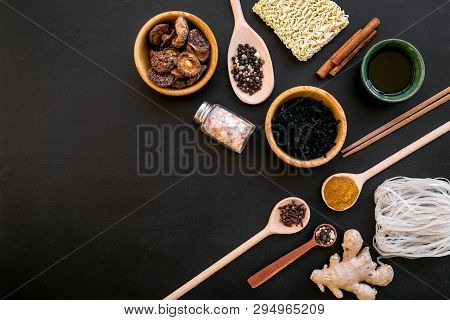 Chinese And Japanese Food Cooking With Ginger, Spices And Noodles On Black Background Top View Mock-