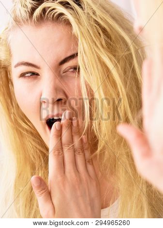 Young Blonde Female Feeling Dull And Tired After Waking Up. Woman Yawning Being Sleepy In Bathroom.