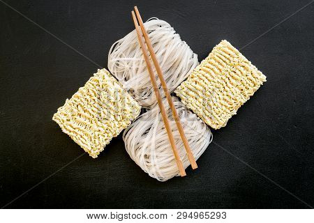 Chinese, Japanese Food Cooking With Rice Vermicelli, Noodles And Sticks On Black Background Top View