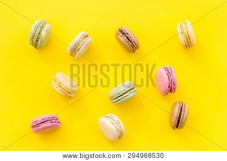 Brignt Macarons For Sweet Break On Yellow Background Top View Pattern