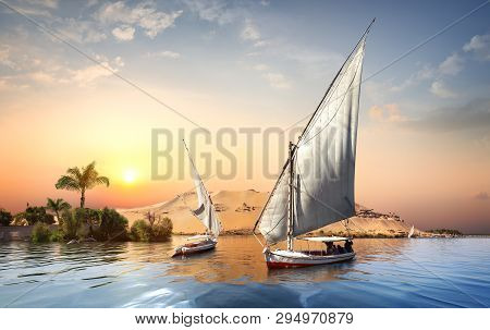 River Nile And Boats At Sunset In Aswan