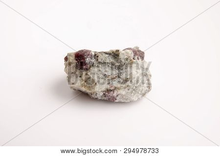 Macro Of A Mineral Garnet Stone On A White Background Close Up