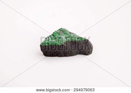Matrix Of Uvarovite Crystals On Rough Rock On White Background
