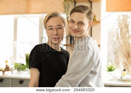Close Up Portrait Of Two Young International Gay Men In Casual Clothes, One Asian Blonde Men In Eyeg