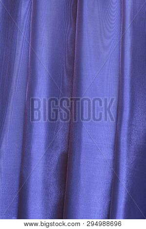 Vertical Folds On Blue Organza Curtains For Background And Design