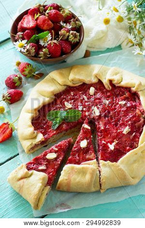 Fresh Homemade Strawberries Galette With Nut Cream On The White Kitchen Table.