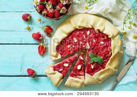 Fresh Homemade Strawberries Galette With Nut Cream On The White Kitchen Table. Top View Flat Lay Bac
