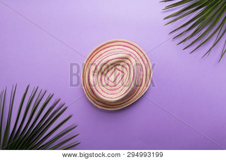 Straw Fashion Summer Hat Isolated On The Violet Or Puprle Backgound, Beach Summer Concept And Holida