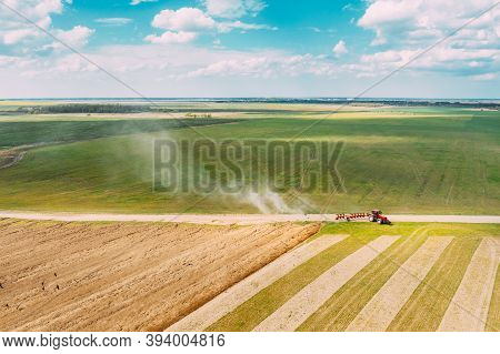 Aerial View. Tractor Plowing Field In Spring Season. Beginning Of Agricultural Spring Season. Cultiv