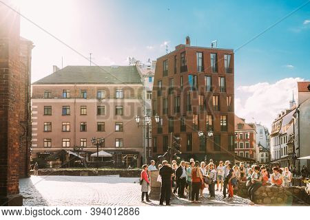 Riga, Latvia - June 9, 2019: Group Of Tourists On Excursions Near Statue Of The Bremen Town Musician