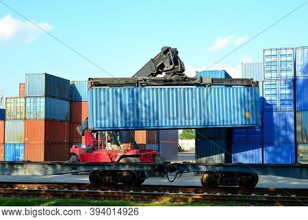 Shipping Container Loading By Richtracker On The Freight Rail Car At Logistic Warehouse Port. Ocean 