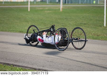Disabled Athlete Training With His Handbike On A Track.