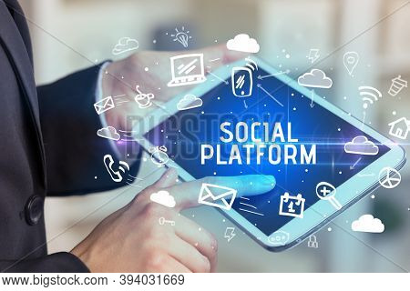 Close-up Of A Person Using Social Networking with SOCIAL PLATFORM inscription