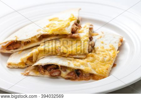 quesadilla filled with beans and chedar cheese