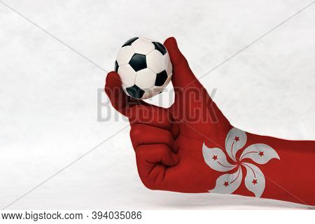 Mini Ball Of Football In Hong Kong Flag Painted Hand, Hold It With Two Finger On White Background. C