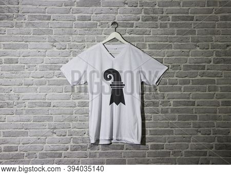Basel-stadt Flag On Shirt And Hanging On The Wall With Brick Pattern Wallpaper. The Canton Of Switze