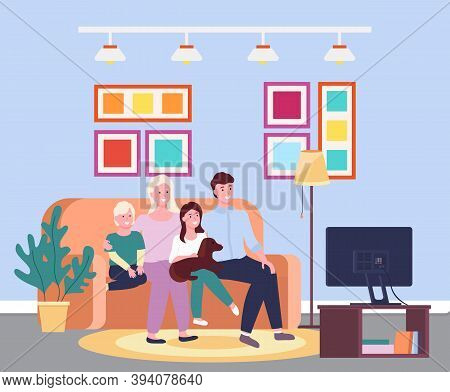 Family Evening At The Tv. Four Member Family Together Smiling Sitting Io The Sofa In Front Of The Te