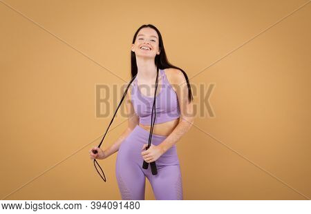 Fitness Concept. Portrait Of Cheerful Sporty Woman With Vitiligo Disorder Holding Jump Rope, Smiling