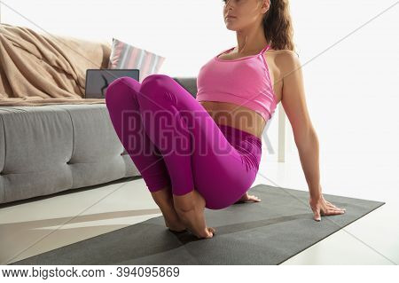 Vitality. Beautiful Young Woman Working Out Indoors, Doing Yoga Exercise On Gray Mat At Home. Long H
