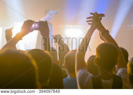 People Hands Silhouette Taking Photo Or Recording Video Of Live Music Concert With Smartphone. Crowd
