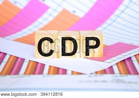 There Is A Piece Of Paper With A Printed Financial Chart On The Table, The Word Is Written On Wooden