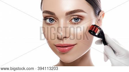 Beautiful Woman During Microneedling Procedure. Beautician Doing Female Skin Treatment Using A Micro