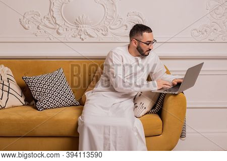 Arabic Programmer Working On Laptop At Home