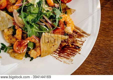 Fresh Salad Plate With Shrimp, Tomato And Mixed Greens On Wooden Background Close Up. Healthy Food.h