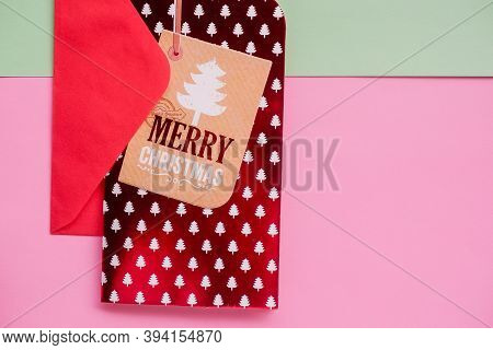 Christmas Envelope With Red Greeying Card On Pastel Green Pink Background. Christmas Holiday Card. T