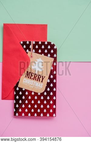 Christmas Envelope With Red Greeying Card On Pastel Green Pink Background. Christmas Holiday Card. T