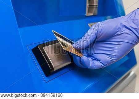 The Hand Of A Person In A Protective Medical Glove Applies A Bank Card To The Terminal And Pays Cont