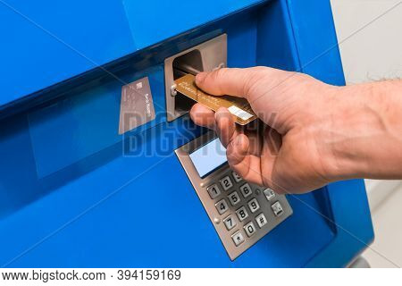 The Guy's Hand Inserts A Bank Card Into An Atm, Close-up