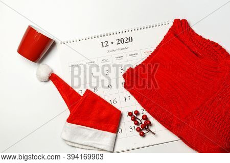 Calendar For December, Red Sweater, Cup And Santa Hat On A White Background, Horizontally, With Spac