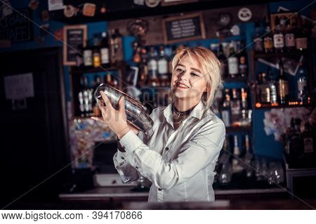 Pretty Barmaid Decorates Colorful Concoction In The Night Club