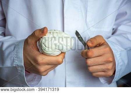 Concept Of Brain Surgery Or Neurosurgery. Neurosurgeon Holding Scalpel In Hand Over 3d Anatomical Mo