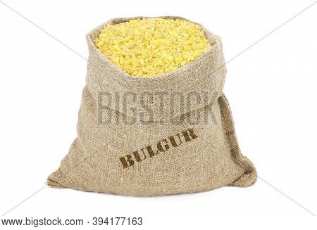 Bulgur Couscous In A Sack Isolated On A White Background. Bulgur In Burlap Sack. Bulgur In Jute Bag.
