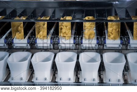 Dry Pasta On Automatic Combination Weighers. Multihead Weighers Machine In Food Industry.
