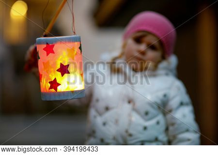 Close-up Of Little Kid Girl Holding Selfmade Lanterns With Candle For St. Martin Procession. Healthy