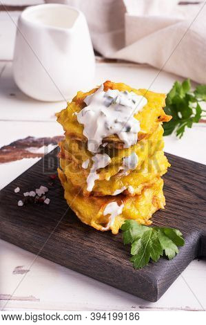 Fried Cakes Of Grated Potatoes On The Plate With Sauce. Traditional Pancakes Boxty Raggmunk.
