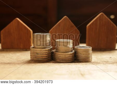 Stach Of Coins With Wood House Model,money Saving Concept For Invesment.