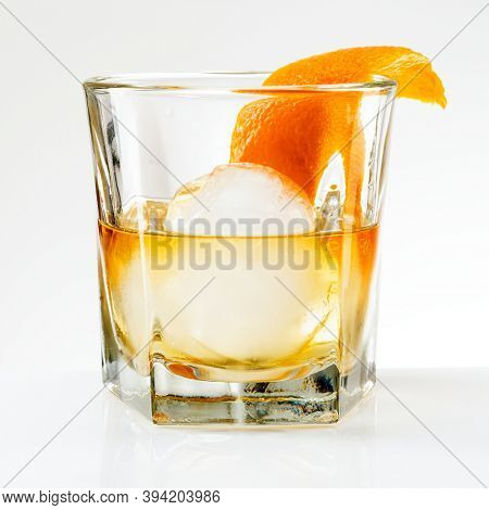 Liquour with an orange peel cocktail