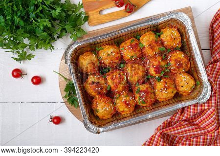 Meatballs In Tomato Sauce Baked In An Aluminum Foil Container. Diet Meat Dish. The Top View