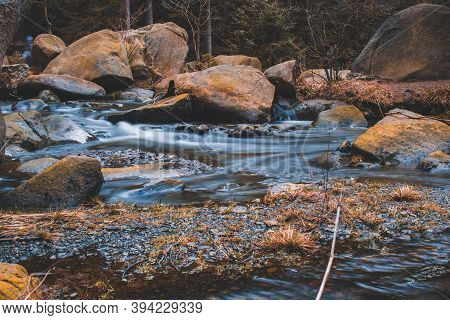 River Oker Flowing Through The Valley Okertal. Wild Scenery Near The Famous Engagement Island (verlo