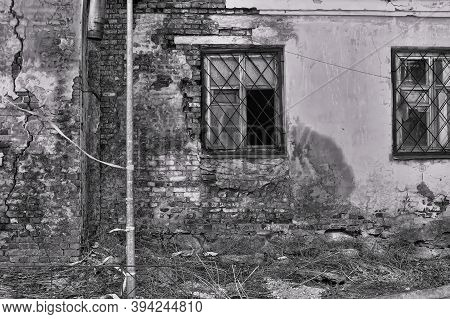Old Collapsing Brick House And Lattice On The Windows