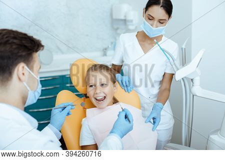 Fast, Painless And Modern Examination And Treatment Of Oral Cavity. Smiling Little Girl Opens Her Mo