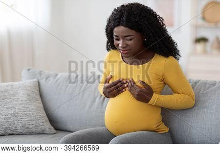 Young Black Pregnant Woman Having Painful Feelings In Breast, Massaging Herself, Free Space. African