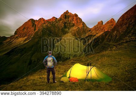 Hiker Man With Backpack And Tent Enjoying Alpenglow At The Mountain Grosser Wilder In Bavarian Alps,
