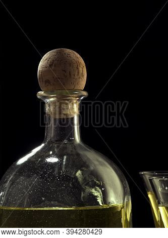 Fragment View Of Bottle Of Tequila Anejo And Glasses On Black Background